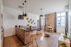 a kitchen and living room with a counter and a table at Totolulu Cannes Luxury Properties in Cannes