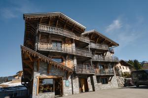 a large wooden building with balconies on it at Hameau des clos Téléporté in Les Gets
