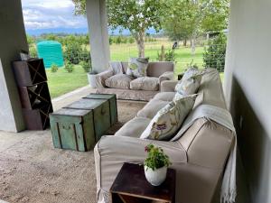 a living room with two couches and a table at Pecan Tree Haven in Winterton