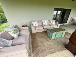 a living room with two couches and a table at Pecan Tree Haven in Winterton