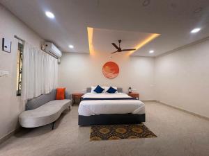 a bedroom with a bed and a ceiling fan at Farm Shaala in Tiruttani