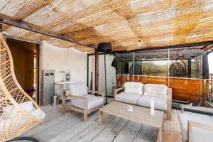 a living room with a couch and a chair at Agriturismo CasaMatilda in Dogliani