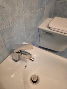 a bathroom with a white sink and a toilet at Nonno Pasquale house in Locorotondo +21 photos