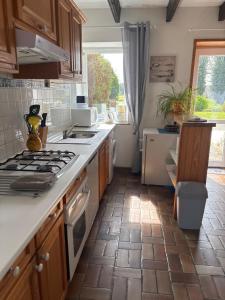 a kitchen with a stove and a counter top at Gites de la Haie in Plouégat-Moysan