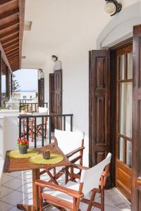 a room with a table and chairs on a balcony at Lagos House Α in Kámpos +30 photos