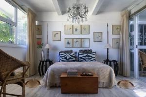a bedroom with a bed and two dogs laying on the floor at The Seaside View in Simonʼs Town +22 photos