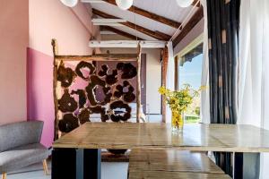 a dining room with a table and a vase of flowers at Agriturismo CasaMatilda in Dogliani