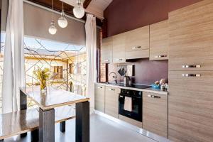 a kitchen with a table and a counter top at Agriturismo CasaMatilda in Dogliani +51 photos