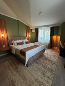 a large bedroom with a large bed in a room at Sawei Urban Hotel in Craiova +75 photos