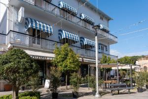 a building with cars on the balconies and a street light at Hotel Centrale in Pineto