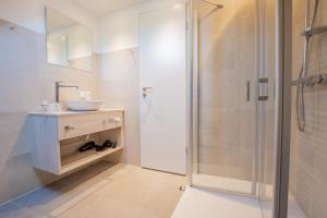 a bathroom with a sink and a shower at BSW Ferienwohnungen Hiddensee in Hiddensee