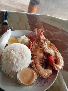 a plate of food with rice and a crab at Port Olry BBQ Table and Camping Side in Port-Olry
