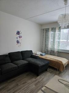 a living room with a couch and a bed at Rivitaloyksiö Vilppulassa in Vilppula