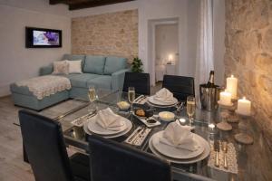 a living room with a table and a blue couch at Didovi dvori in Bibinje