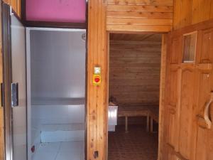 a wooden door leading into a sauna with a bench at Kismet Hideaway in Nairobi