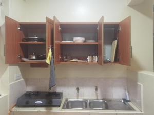 a kitchen with a sink and a stove in it at Kismet Hideaway in Nairobi +14 photos