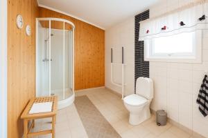 a bathroom with a toilet and a shower at Guesthouse in Hellosan in Vestvågøya