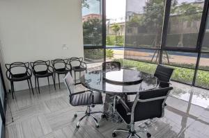 a conference room with a glass table and chairs at Amazing High Floor Luxury Studio in Sathani Ban Hua Mak