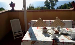 a table on a balcony with a view of the ocean at Magic View in Tuscany in Capo D'Arco +18 photos