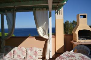 a bedroom with a view of the ocean from a balcony at Magic View in Tuscany in Capo D'Arco