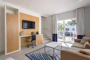 a living room with a couch and a desk at Pestana South Beach Miami in Miami Beach