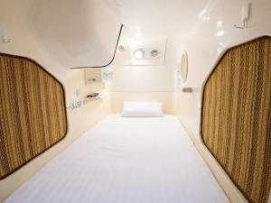 a small room with a bed in the middle at A-GATE Hotel Hakodate in Hakodate