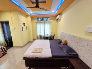 a bedroom with a bed and a table in it at Nmck Homestay in Guwahati