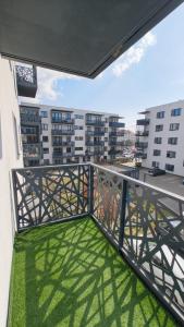 a balcony with green grass on a building at YoniHarmony - 2 parking places in Sosnowiec +6 photos