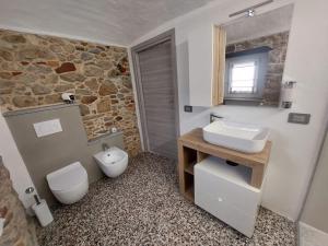 a bathroom with a white sink and a toilet at Affittacamere il Gallo Panoramico - Alpine Trekking Stay in Donato +12 photos