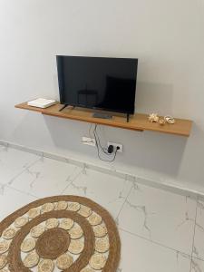 a tv sitting on a shelf on a wall at Apartamentos Andrade in Espargos
