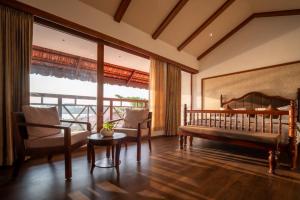 a bedroom with a bed and a table and chairs at VIHARA By CMK in Cochin