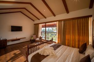 a bedroom with a bed and a large window at VIHARA By CMK in Cochin
