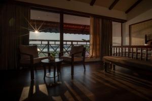 a room with a bed and a table and a window at VIHARA By CMK in Cochin