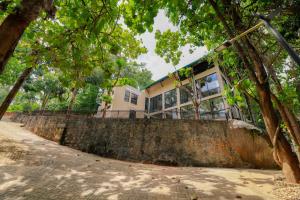a house on top of a stone wall at Dilco Nature Resort - BERAGALA in Dambawelagama