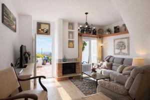 a living room with a couch and a fireplace at Luxury House - Montesol ALBERT VILLAS in Alcossebre