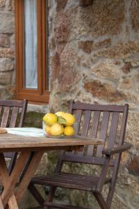 a bowl of fruit sitting on a wooden table at A Banda do Río in Vilagarcia de Arousa +36 photos