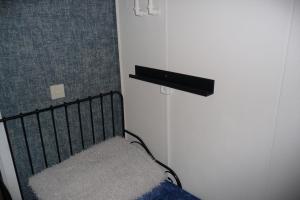 a bedroom with a bed and a shelf on the wall at Villa Rosa in Andijk