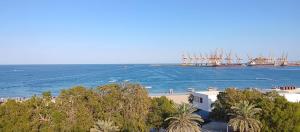 a view of the ocean and a beach with a ship at Coral Bay King Studio in Khor Fakkan +4 photos