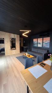 a living room with a couch and a table at Nomad Hill Cabins in Rugineşti +35 photos