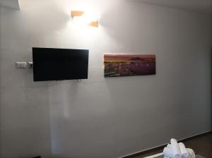 a flat screen tv hanging on a wall at Brezza Marina in Cirella