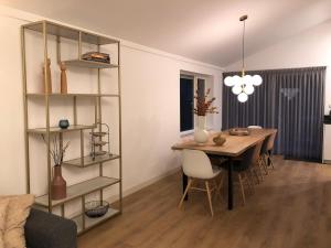 a living room with a table and a dining room at Villa Veluwe in Putten