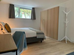 a hotel room with a bed and a window at Villa Veluwe in Putten