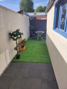 a small courtyard with a table and a plant at L Atelier de papa in Dargnies