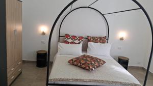 a bedroom with a bed with an iron canopy at La Casa del Faro in Taranto