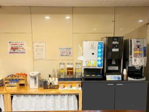 a coffee shop with a counter with a coffee machine at A-GATE Hotel Hakodate in Hakodate