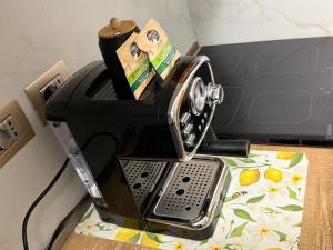 a toaster oven sitting on top of a table at Casa vacanze by Michele in Verbania