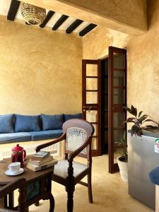a living room with a blue couch and a table at Shela Bahari in Shela