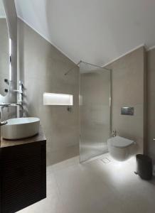a bathroom with a shower and a sink and a toilet at Valeria's Apartment in Argostoli