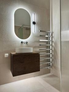a bathroom with a sink and a mirror at Valeria's Apartment in Argostoli
