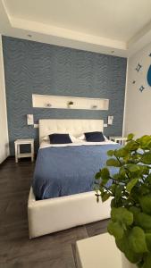a bedroom with a king sized bed with blue sheets at CIVICO 29 in Pompei